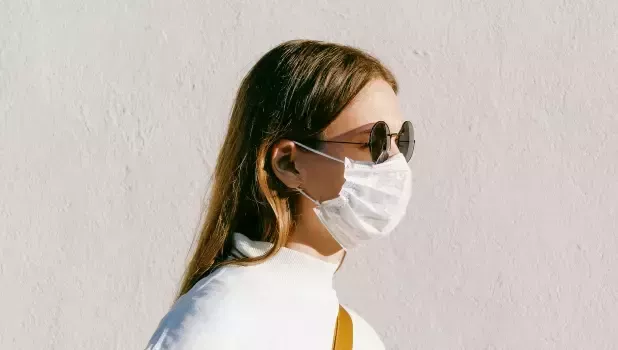 An image of a woman wearing a nose mask